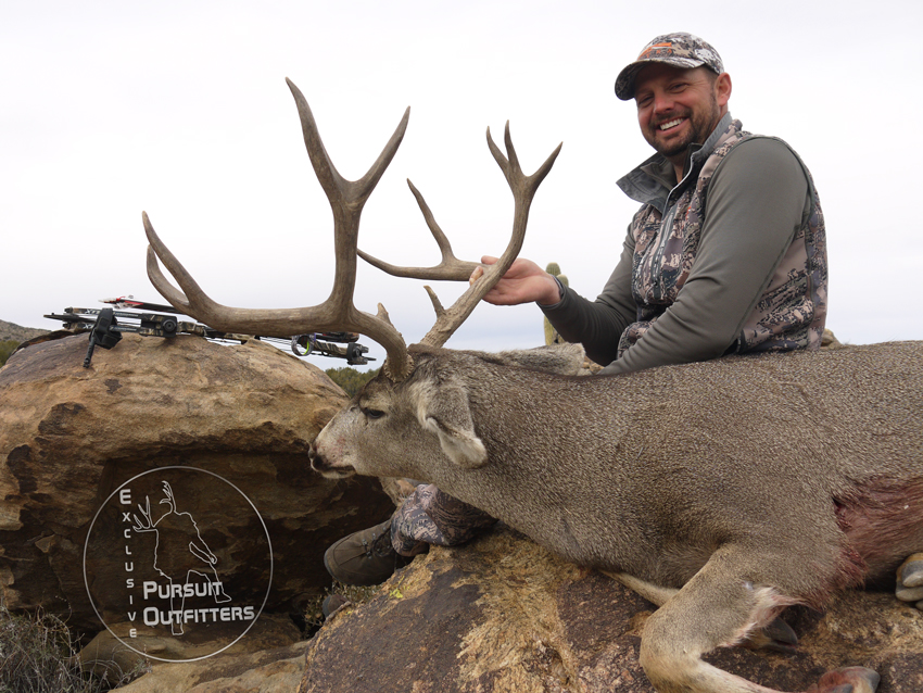 Troy holding his biggest archery mule deer. 